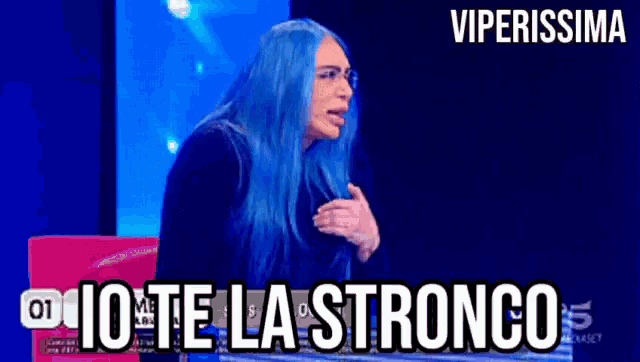 a woman with blue hair is sitting in front of a computer screen with the words viperissima above her