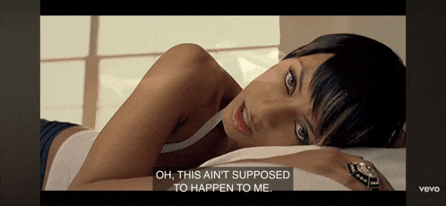 a woman is laying on a bed with the words oh this ain t supposed to happen to me