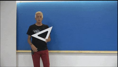 a man holding a triangle in front of a blue board that says global optical