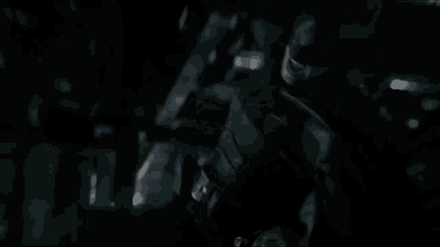 a blurry picture of a dark room with a green light coming out of the ceiling .