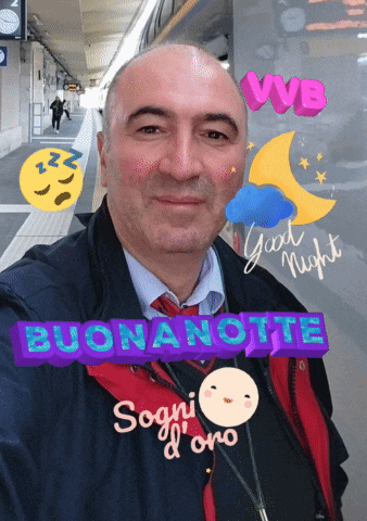 a man is standing in front of a window that says buonanotte