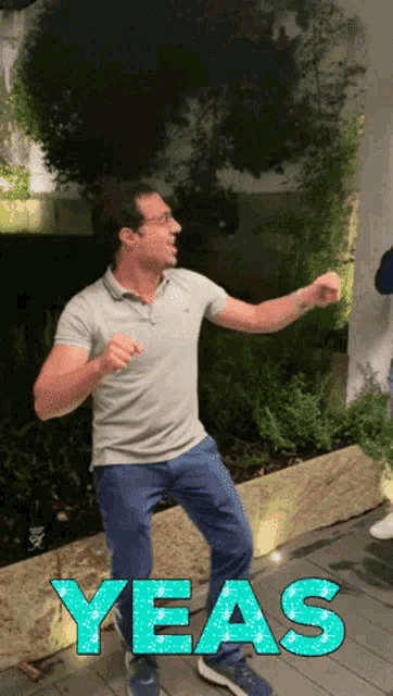 a man is dancing in front of a sign that says yes