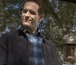 a man is standing in front of a tree and talking to another man who could have predicted that .