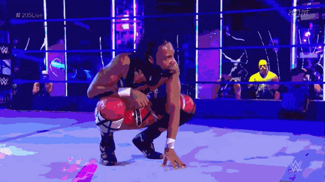 a wrestler is kneeling down in a wrestling ring with the hashtag # 205live