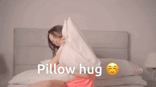 a woman is hugging a pillow with the words pillow hug written below her