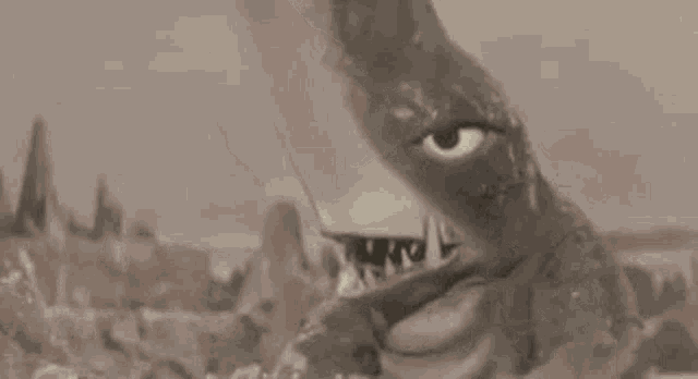 a close up of a monster with a shark 's head and mouth .