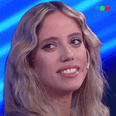 a close up of a woman 's face with a nose ring on it
