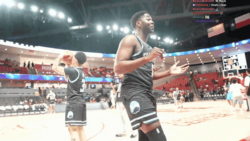 a basketball player with the number 2 on his jersey stands on the court