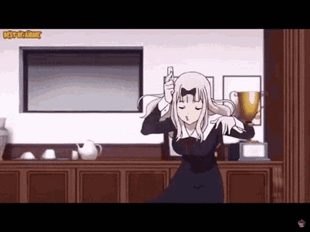 a girl in a black dress is holding a trophy and dancing in a room .