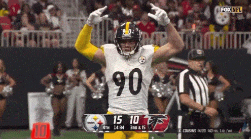 a football player with the number 90 on his jersey is celebrating