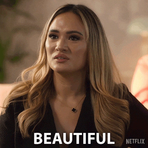 a woman with a necklace and the word beautiful on the bottom right