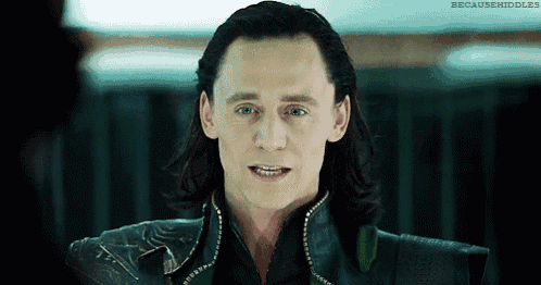 a close up of a man 's face with long hair and a smile .