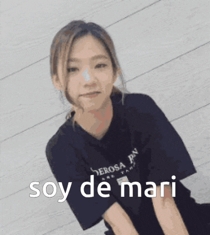 a young woman is smiling and wearing a black shirt with the words soy de mari written on it .