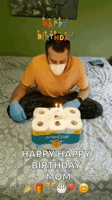 a man wearing a mask is sitting on a bed with a birthday cake made out of toilet paper rolls