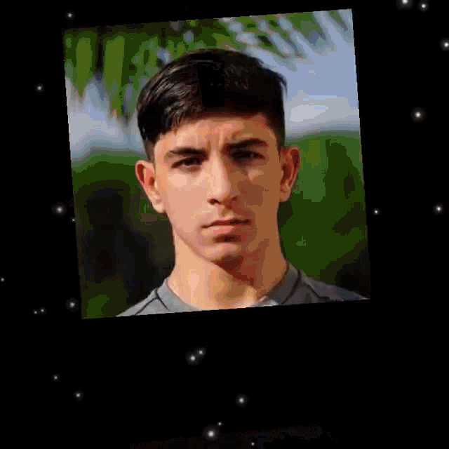 a close up of a young man 's face with a blurred background .
