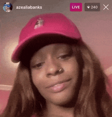 a woman wearing a pink hat is live on azealiabanks