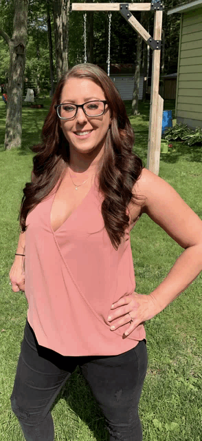 a woman wearing glasses and a pink tank top