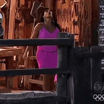 a woman in a pink dress is running across a field
