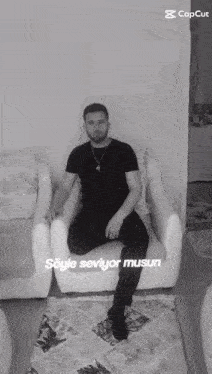 a black and white photo of a man sitting in a chair with the caption " söyle seviyor musun " on the bottom