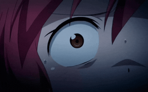 a close up of a person 's eye with a red hair