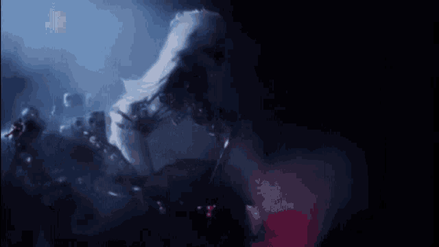 a person in a white costume is standing in the dark