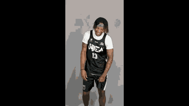 a man wearing a jersey that says 13 on it