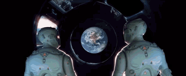 a couple of astronauts looking at the earth in space