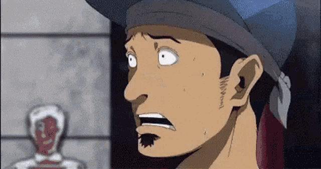 a man wearing a bandana and a hat is looking at something with a surprised look on his face .