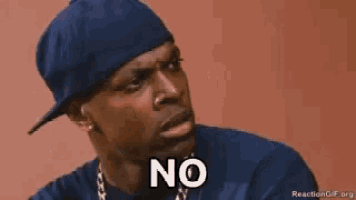a man wearing a hat and a blue shirt is making a funny face and saying no .