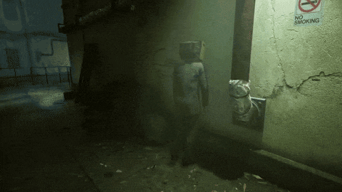 a no smoking sign is on a wall in a dark alleyway