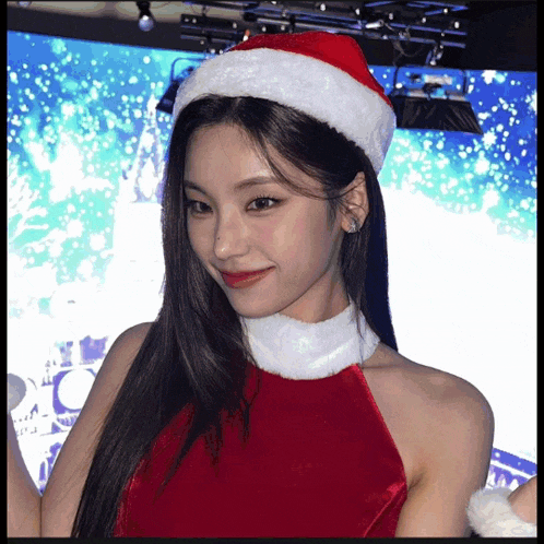 a woman is wearing a santa hat and dress