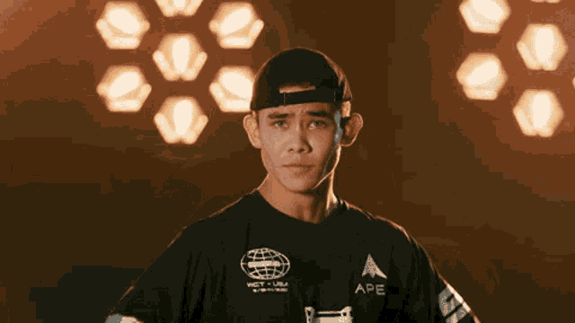 a young man wearing a black shirt that says ape