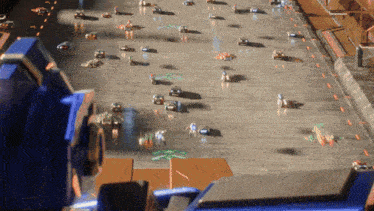 a bunch of cars are driving down a road with a blue transformer in the foreground