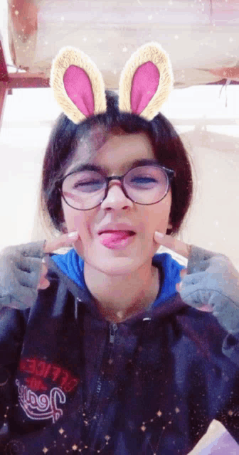 a girl wearing bunny ears and a sweatshirt that says jeep on it