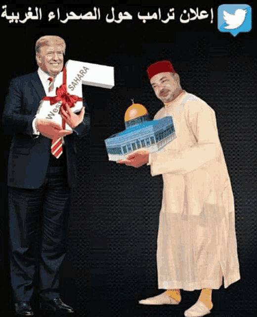 two men are standing next to each other and one is holding a box that says sahara