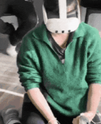 a person wearing a green sweater and white helmet