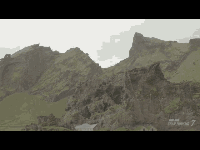 a mountain with a gran turismo logo in the background