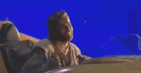 a man with a beard is sitting in a futuristic vehicle .