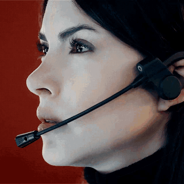a close up of a woman wearing a headset with the letters o on it