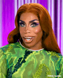 a drag queen with red hair is wearing a green dress with a purple background .