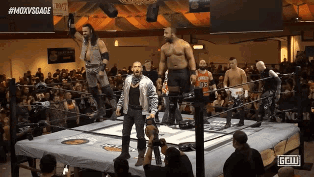a group of wrestlers are standing in a ring with the hashtag #moxvsgage