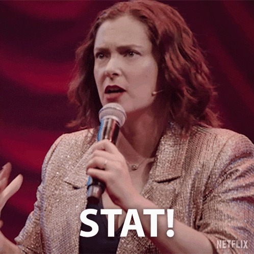 a woman is holding a microphone and says stat .