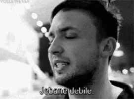 a black and white photo of a man with his eyes closed and the words jebane debile written on his face .