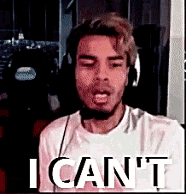 a man wearing headphones is making a funny face and says i can 't .