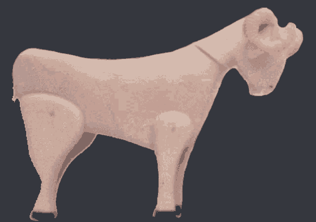 a statue of a bull with horns is against a black background