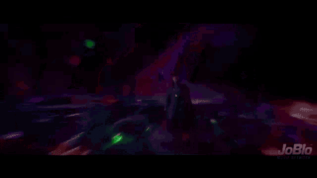 doctor strange is holding a green light in his hand .