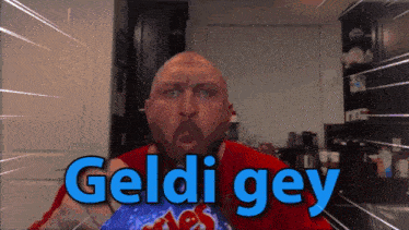 a bald man in a red shirt with the word geldi gey written on it