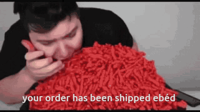 a man eating a pile of red cheetos with the words " your order has been shipped ebed " above him