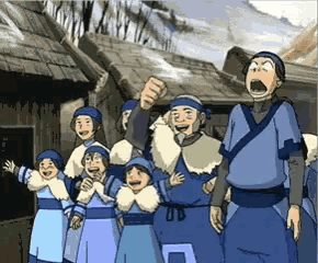 a group of people in blue clothes are standing together