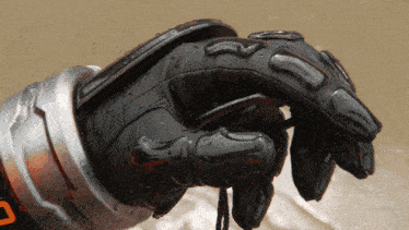 a close up of a person 's hand wearing a black glove with the letter d on it
